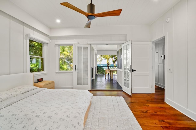 bedroom with dark hardwood / wood-style floors, ceiling fan, wood ceiling, and french doors