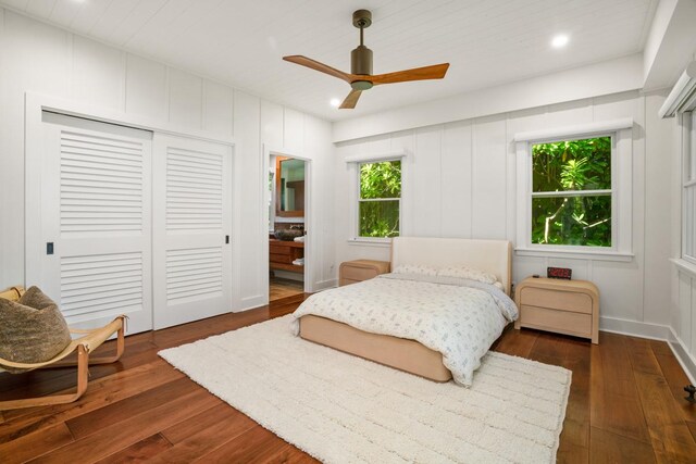 bedroom with ceiling fan, dark hardwood / wood-style flooring, and a closet