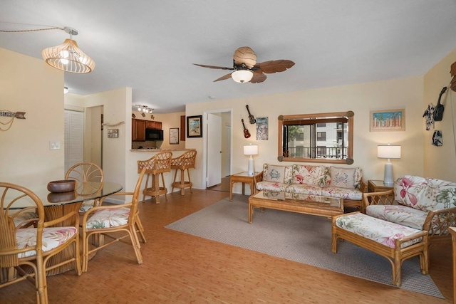 living room with ceiling fan and hardwood / wood-style floors