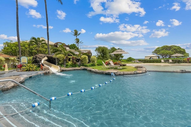 view of swimming pool with a water slide