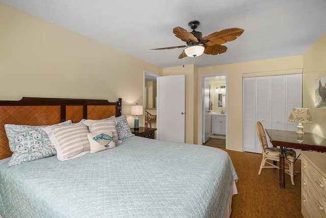 carpeted bedroom featuring ensuite bathroom, a closet, and ceiling fan