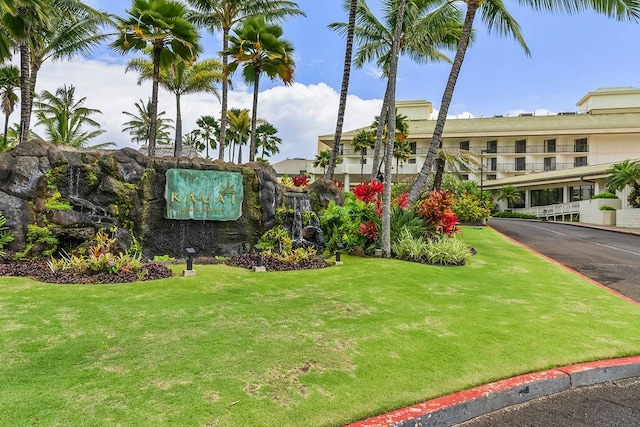 view of front of home featuring a balcony and a front lawn