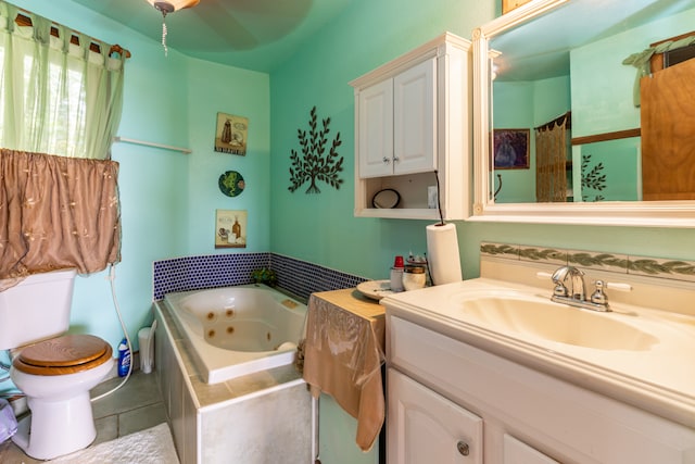 bathroom featuring tile flooring, ceiling fan, oversized vanity, a relaxing tiled bath, and toilet