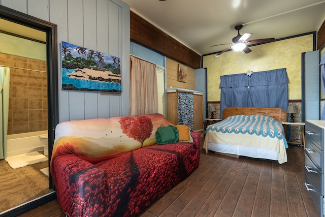 bedroom with connected bathroom, ceiling fan, and dark hardwood / wood-style floors