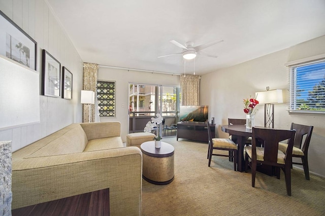 carpeted living room featuring ceiling fan