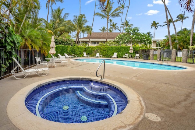 view of swimming pool with a community hot tub and a patio area