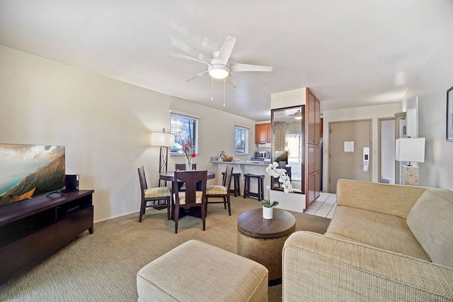 living room featuring light colored carpet and ceiling fan