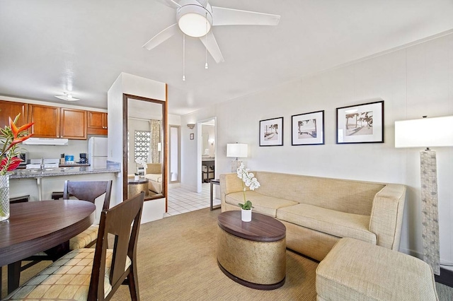 living room with ceiling fan, sink, and light carpet