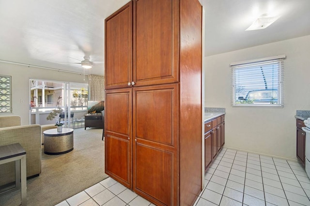 kitchen with ceiling fan and light tile floors