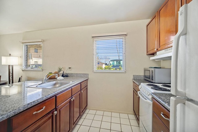 kitchen with sink, white appliances, light stone counters, and light tile floors