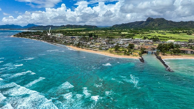 bird's eye view with a view of the beach and a water and mountain view