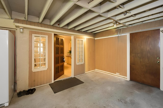 basement with white refrigerator