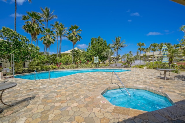 view of pool featuring a patio and a community hot tub