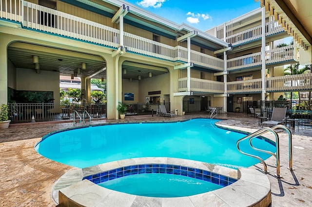 view of swimming pool with a patio and a hot tub