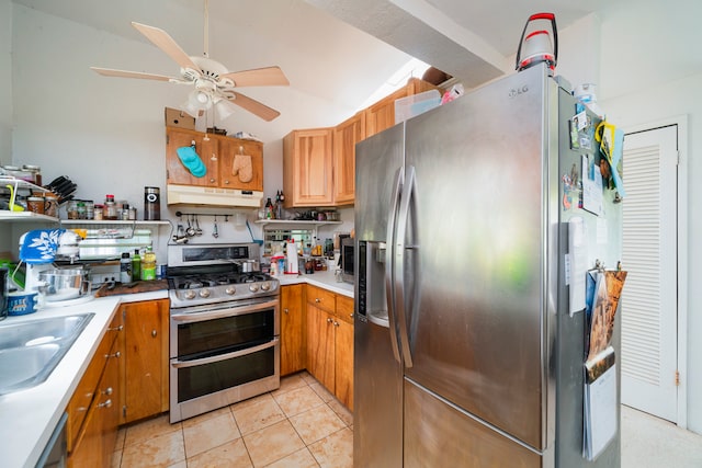 kitchen with appliances with stainless steel finishes, light tile floors, sink, vaulted ceiling, and ceiling fan