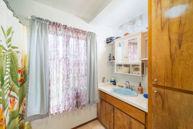 bathroom featuring oversized vanity and tile flooring