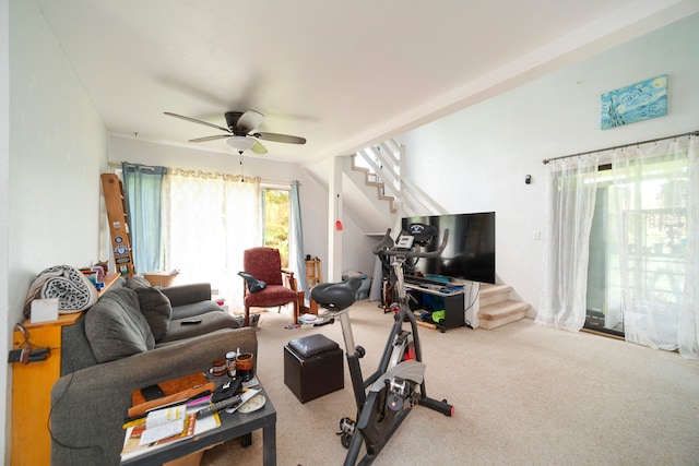 carpeted living room with ceiling fan