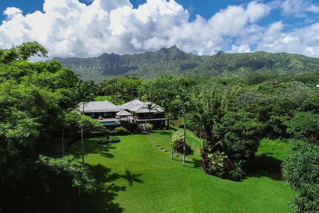 exterior space with a lawn and a mountain view