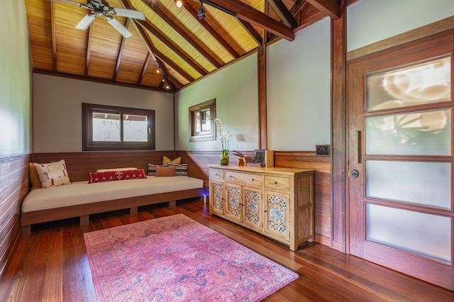 sitting room featuring dark hardwood / wood-style floors, beam ceiling, ceiling fan, and wooden ceiling