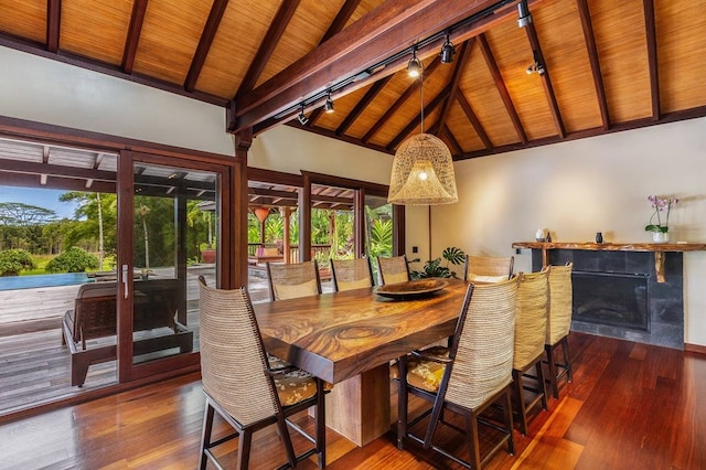 dining space with beamed ceiling, dark hardwood / wood-style floors, rail lighting, high vaulted ceiling, and wood ceiling