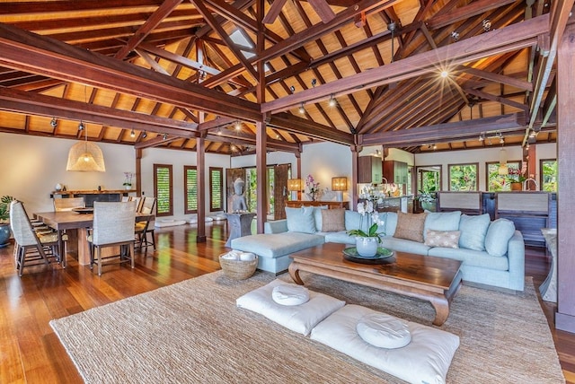 living room featuring high vaulted ceiling, wood ceiling, dark wood-type flooring, and beamed ceiling