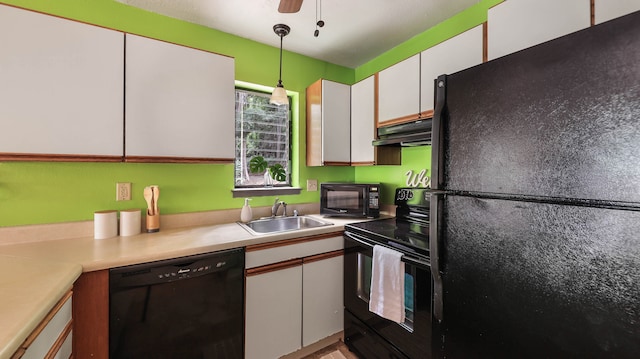 kitchen with black appliances, white cabinets, sink, hanging light fixtures, and ceiling fan