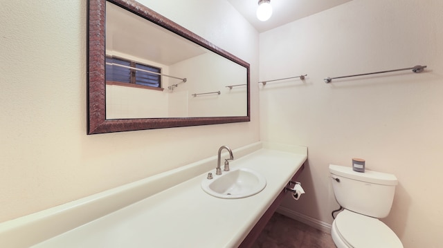 bathroom with toilet and vanity