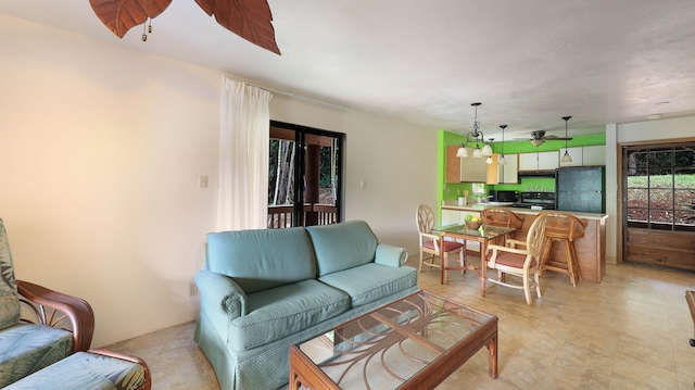 tiled living room with ceiling fan