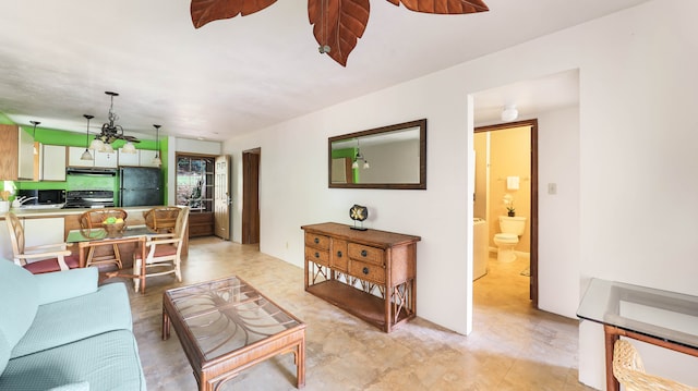 living room featuring light tile patterned flooring, sink, and ceiling fan