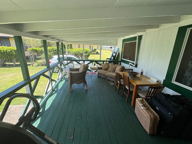 wooden deck featuring an outdoor hangout area and a lawn