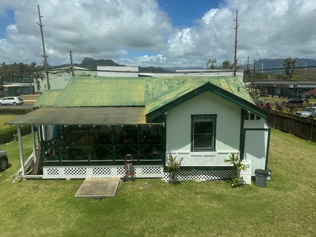 rear view of house with a yard