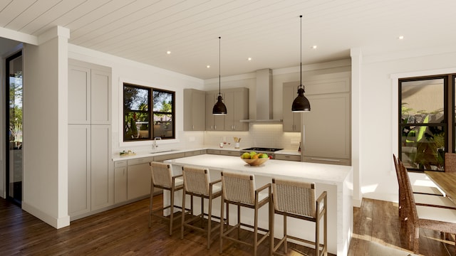 kitchen with a kitchen island, backsplash, gray cabinetry, wall chimney exhaust hood, and sink