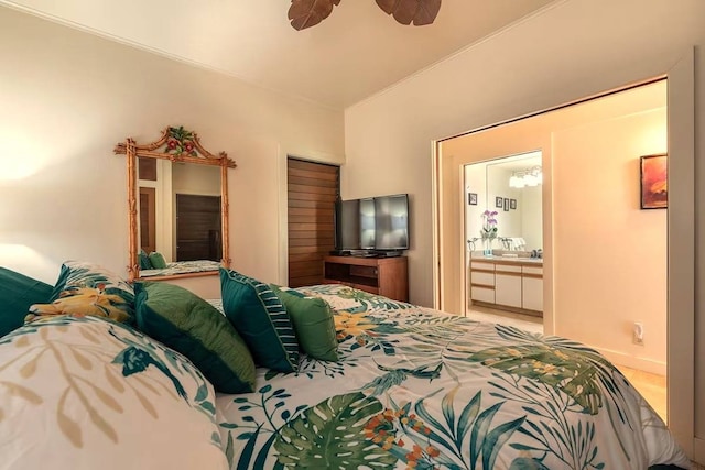 bedroom featuring light colored carpet, ceiling fan, and ensuite bathroom