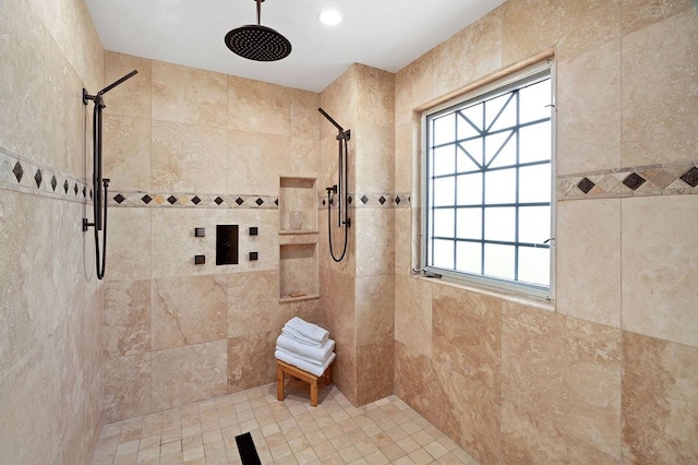 bathroom featuring a healthy amount of sunlight and tiled shower