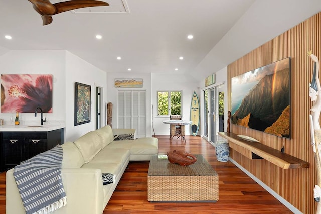 living room with sink, ceiling fan, and dark wood-type flooring