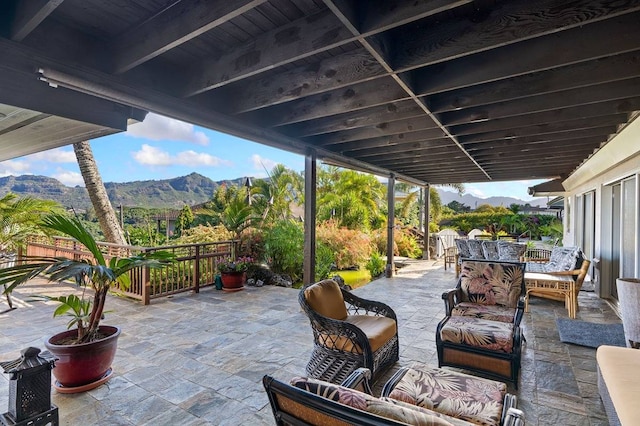 view of terrace with a mountain view and an outdoor hangout area