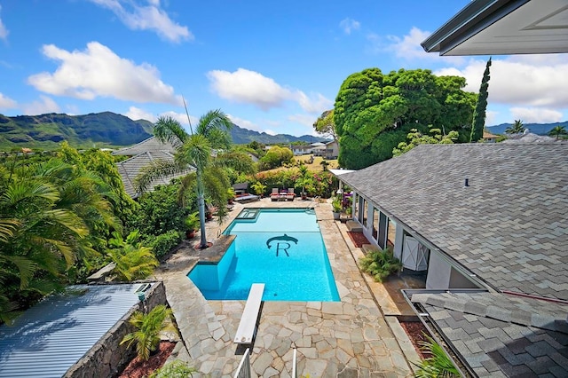 view of swimming pool with a patio area and a mountain view