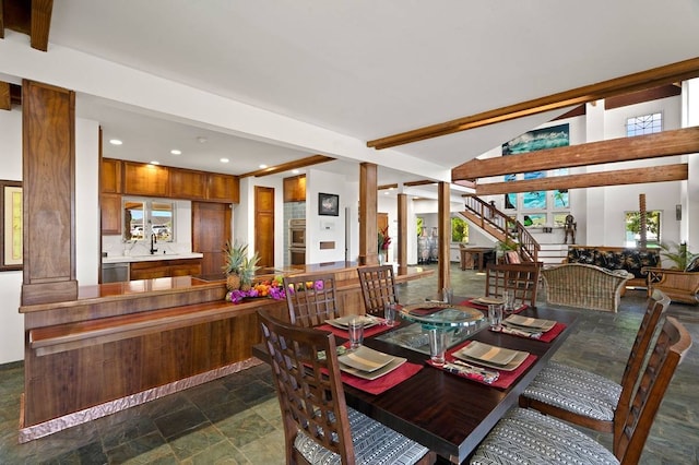 tiled dining space featuring beamed ceiling and decorative columns