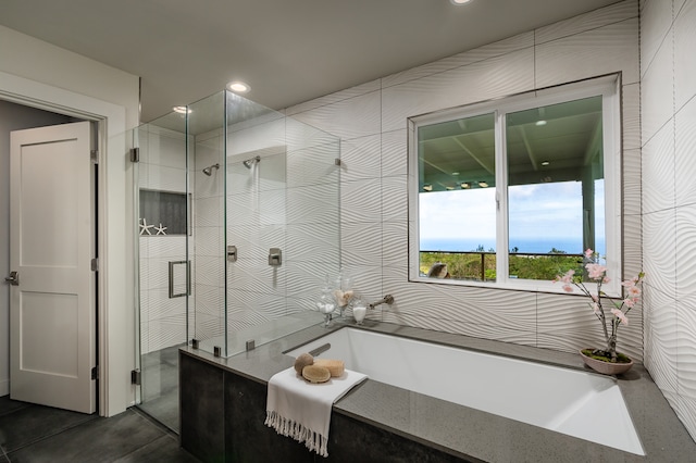 bathroom with tile patterned flooring and independent shower and bath