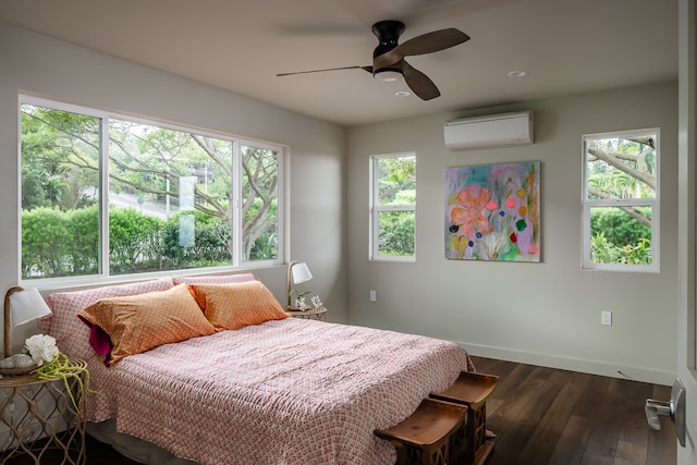 bedroom with a wall mounted AC, dark hardwood / wood-style flooring, and ceiling fan