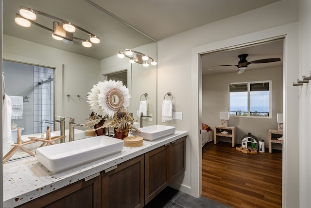 bathroom with double vanity, wood-type flooring, and ceiling fan