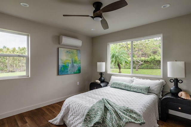 bedroom with dark wood-type flooring, multiple windows, a wall mounted air conditioner, and ceiling fan