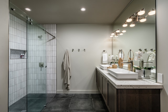 bathroom with a shower with door, tile patterned flooring, and double sink vanity