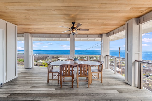 deck with ceiling fan and a water view