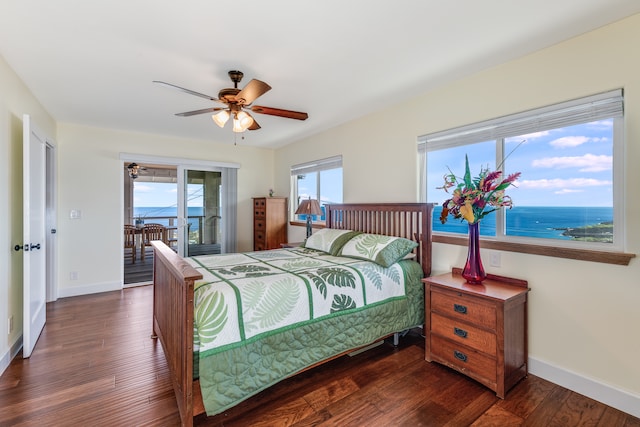 bedroom featuring ceiling fan, a water view, access to exterior, and dark wood-type flooring