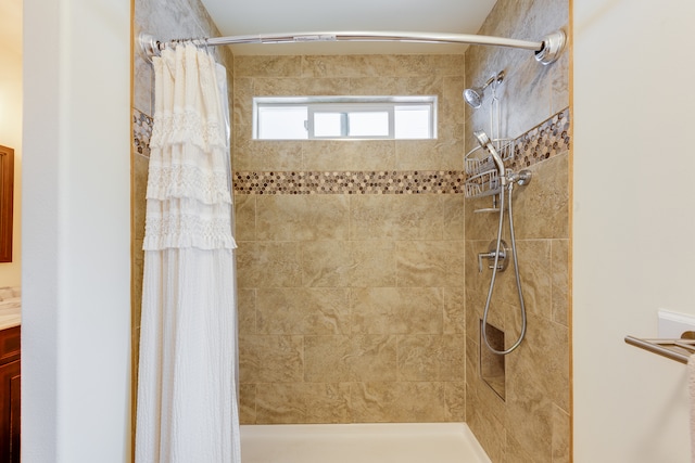 bathroom with walk in shower and vanity