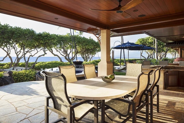 view of patio featuring ceiling fan and an outdoor bar