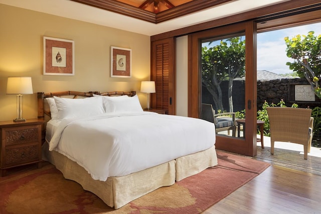 bedroom with crown molding, access to outside, and light hardwood / wood-style flooring