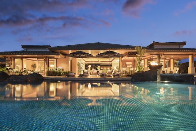 view of pool at dusk