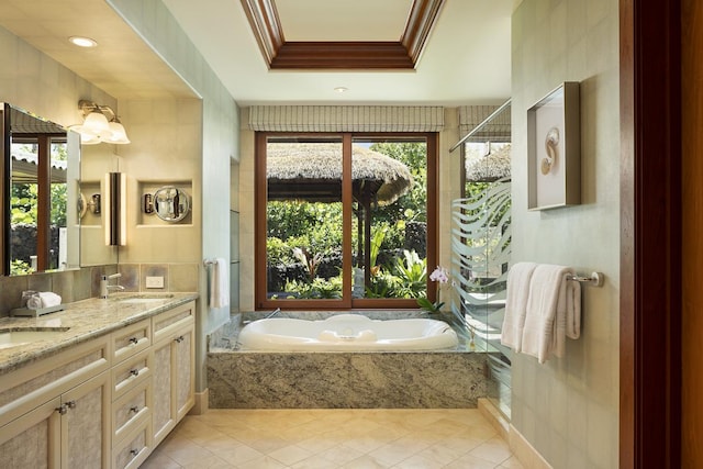 bathroom with tile patterned floors, vanity, a raised ceiling, and ornamental molding